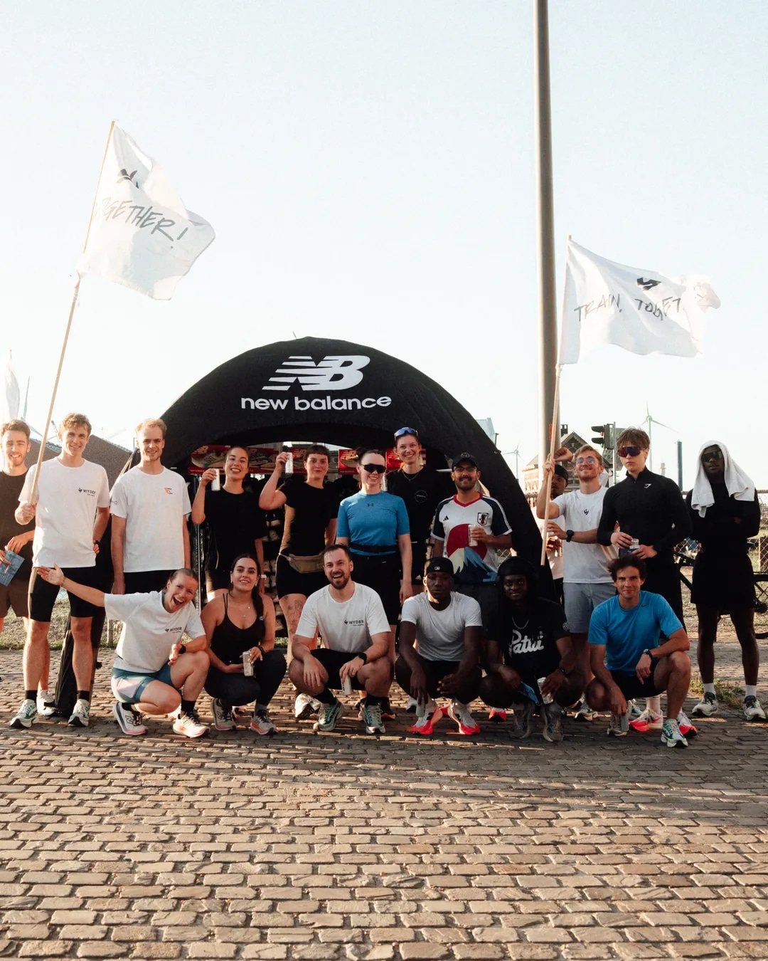 Wyder and New Balance group photo in front of the event tent